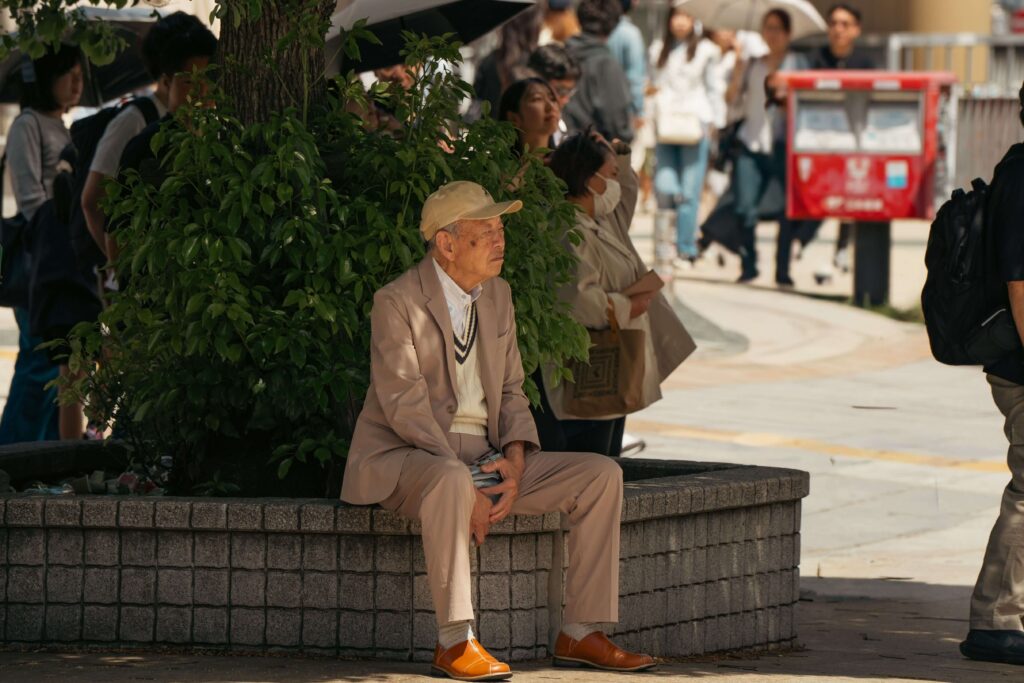 Elderly Japanese man sitting on a bench