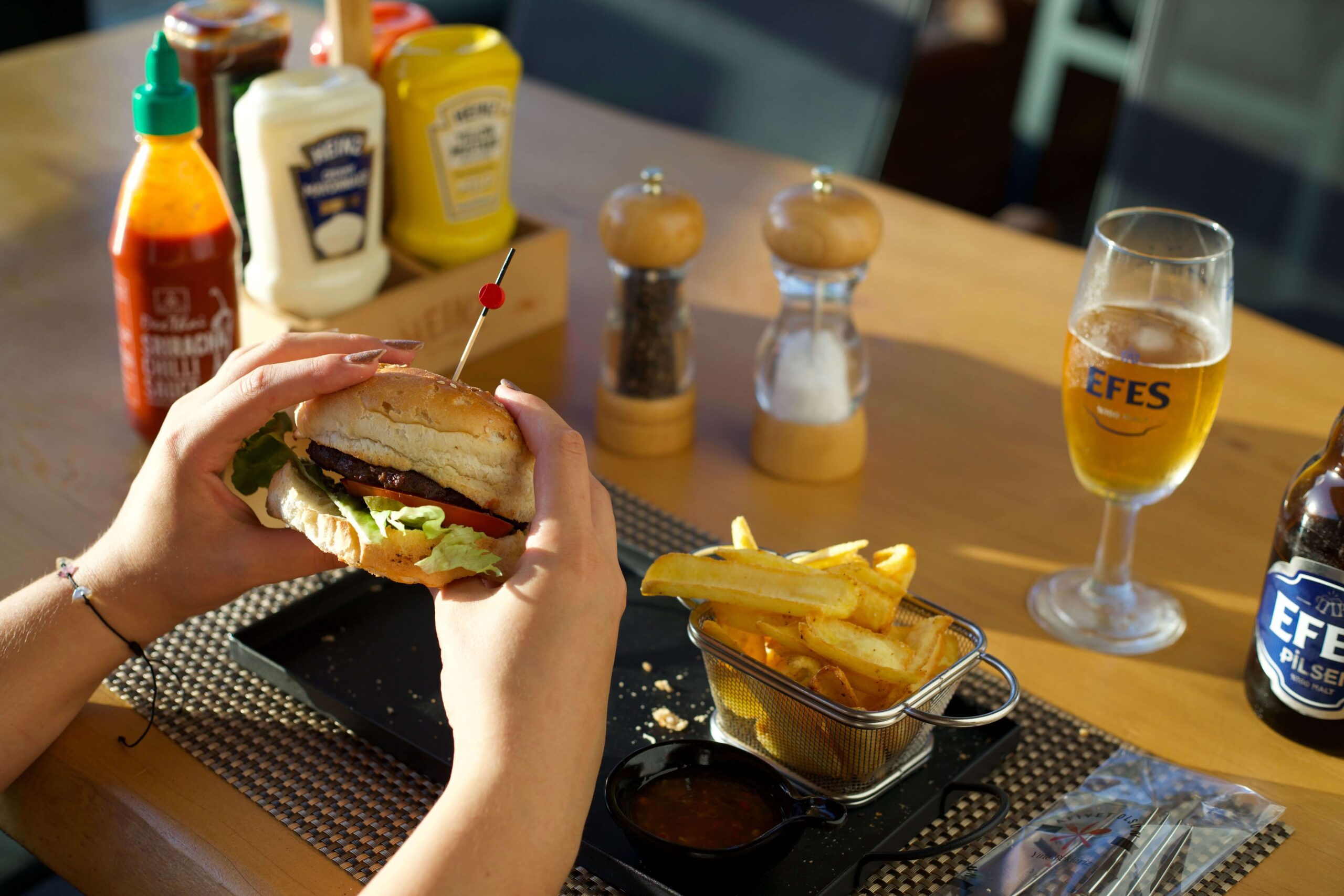 Image of a person eating a burger in a restaurant 